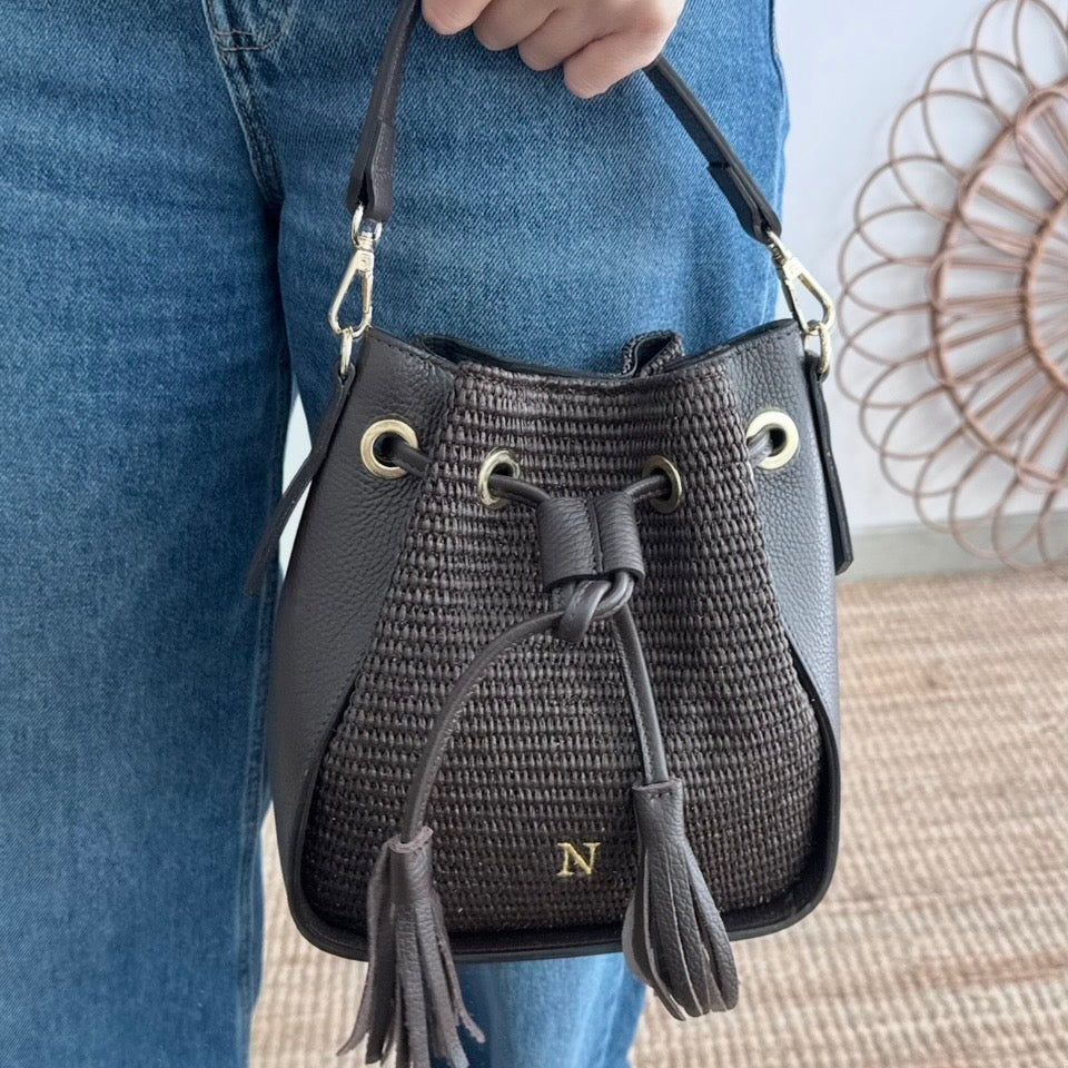 Bolso bucket combinado piel y rafia marrón pompón iniciales bordadas