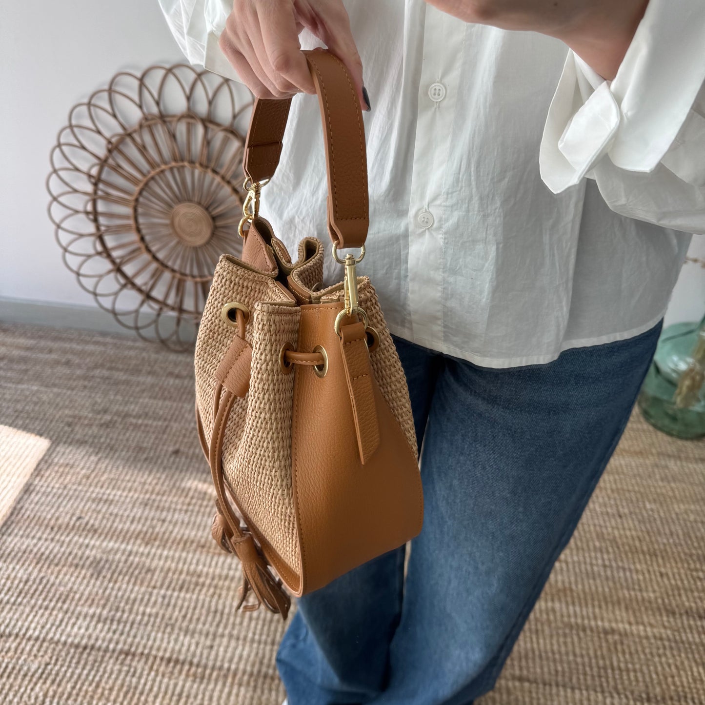 Bolso bucket combinado rafia y piel camel pompón iniciales bordadas