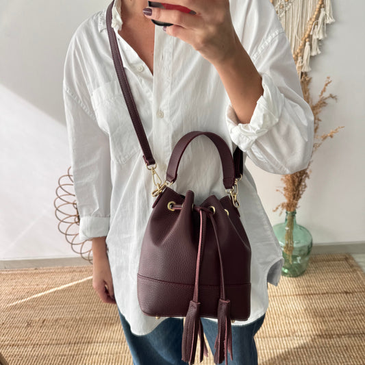 Bolso bucket piel granate pompón iniciales bordadas