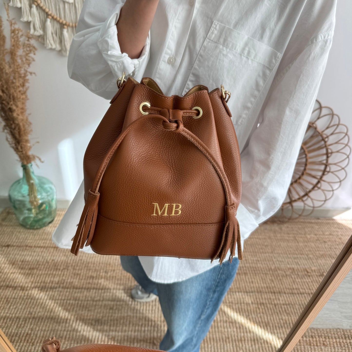 Bolso bucket piel camel grande pompón iniciales bordadas