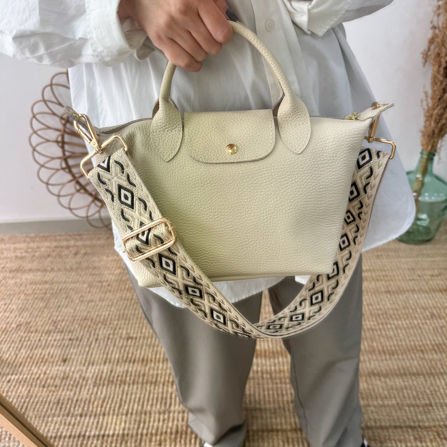 Bolso ovalado piel beige solapa iniciales bordadas