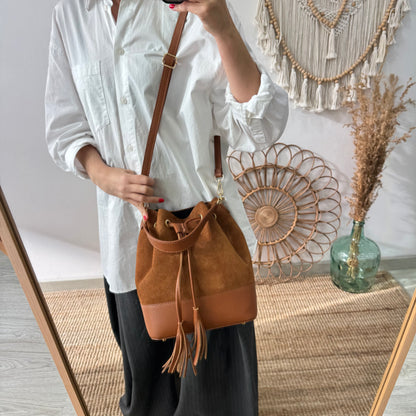 Bolso bucket serraje y piel camel grande pompón iniciales bordadas