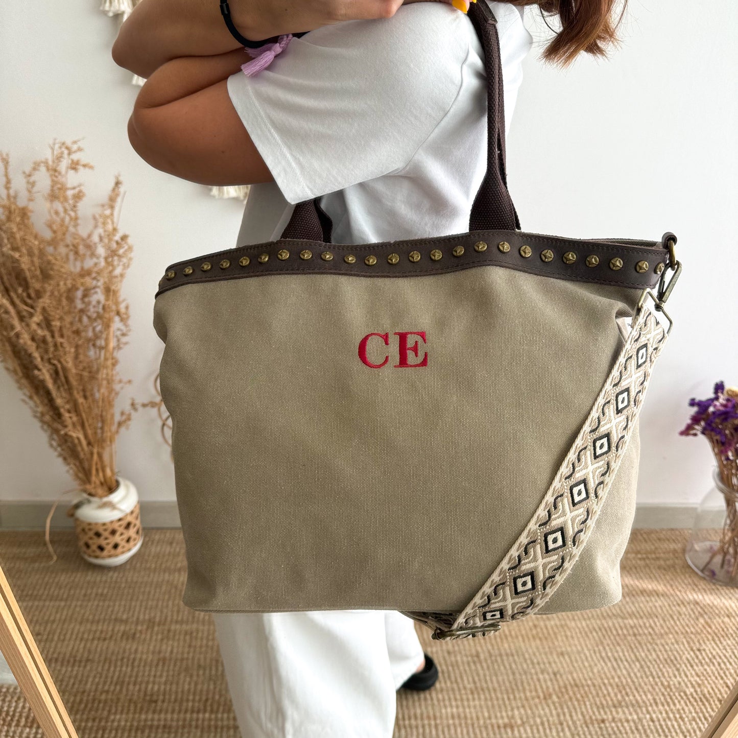 Bolso shopper loneta y piel taupe tachuelas iniciales bordadas con correa étnica