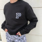 SUDADERA CUELLO REDONDO NEGRO INICIAL BORDADA